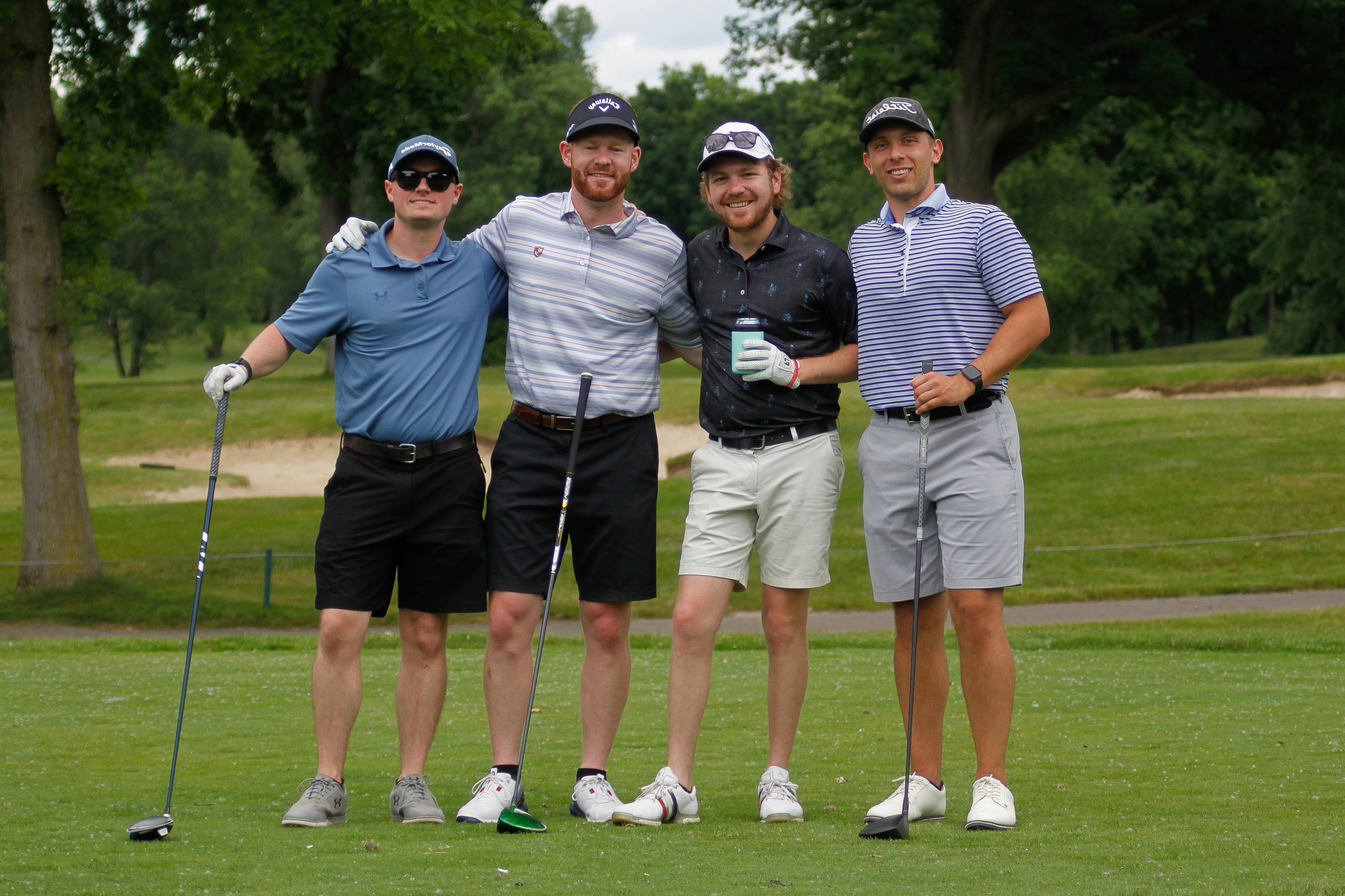 Alumni posing at the golf outing